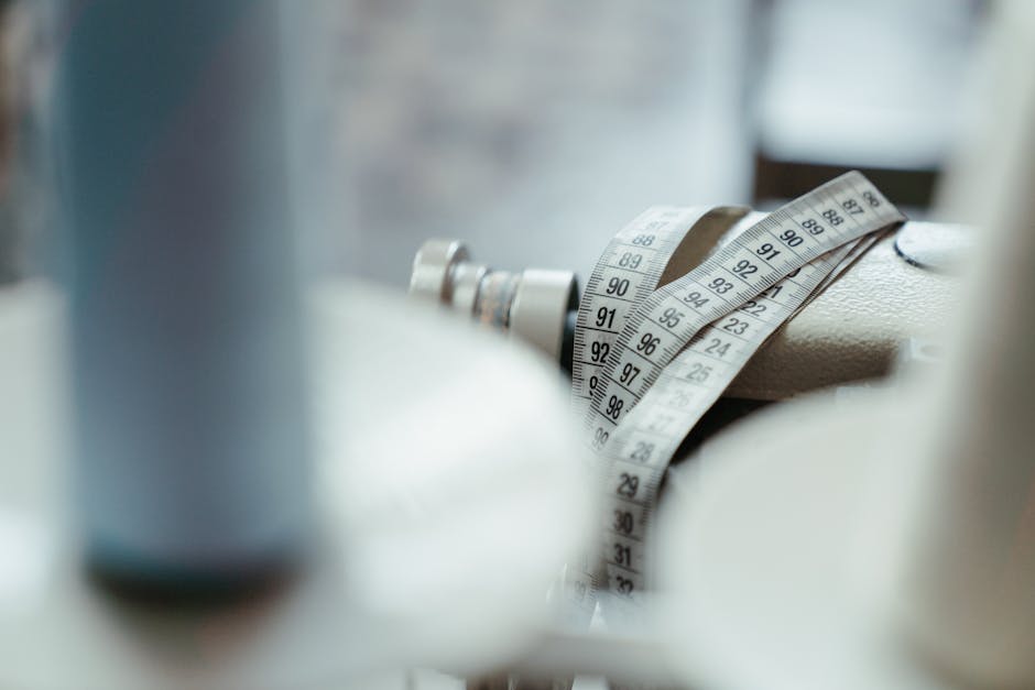 A sewing machine with a measuring tape draped over, emphasizing tailoring and craftsmanship.