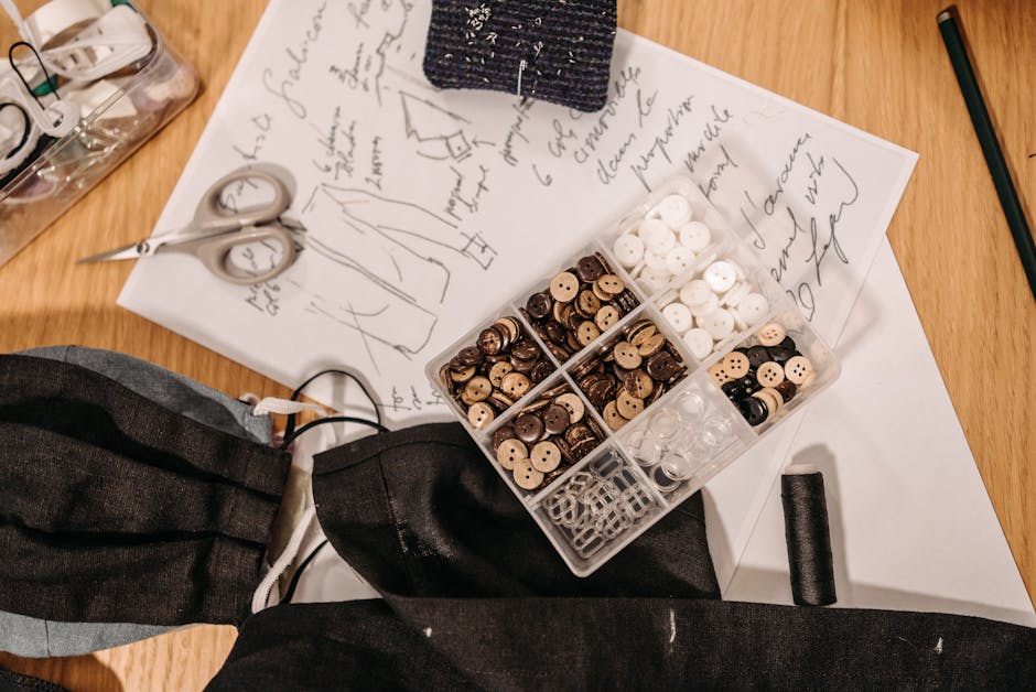 Flat lay of sewing tools and fabric designs, showcasing creativity and craftsmanship.